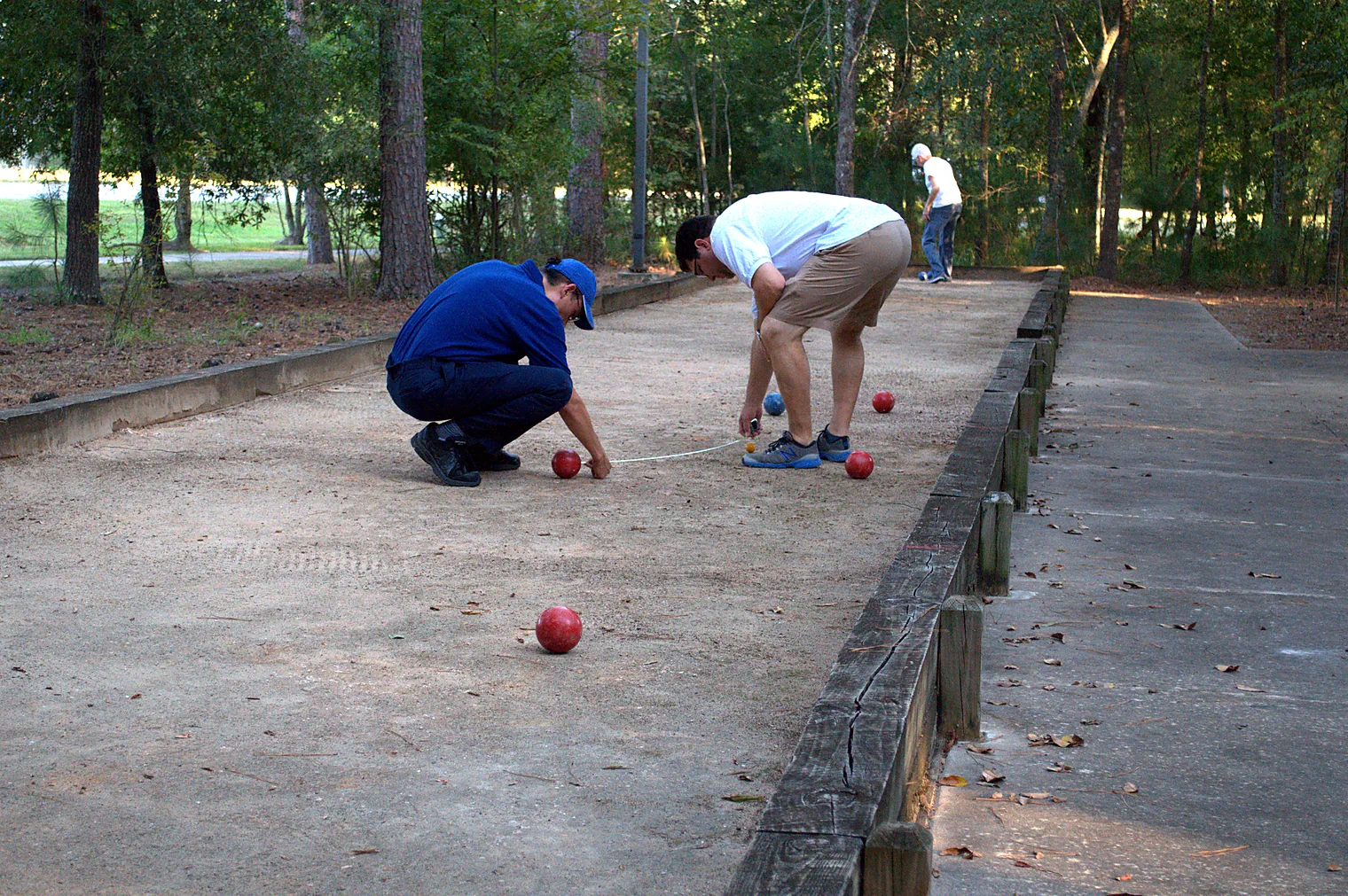 Players measuring which ball is closest to the pallino at Avalon Park, Village of College Park