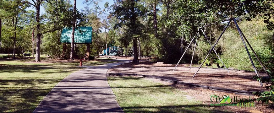 Clover Park The Woodlands Panther Creek Village Path and swing set at Clover Park and Pond, Village of Panther Creek