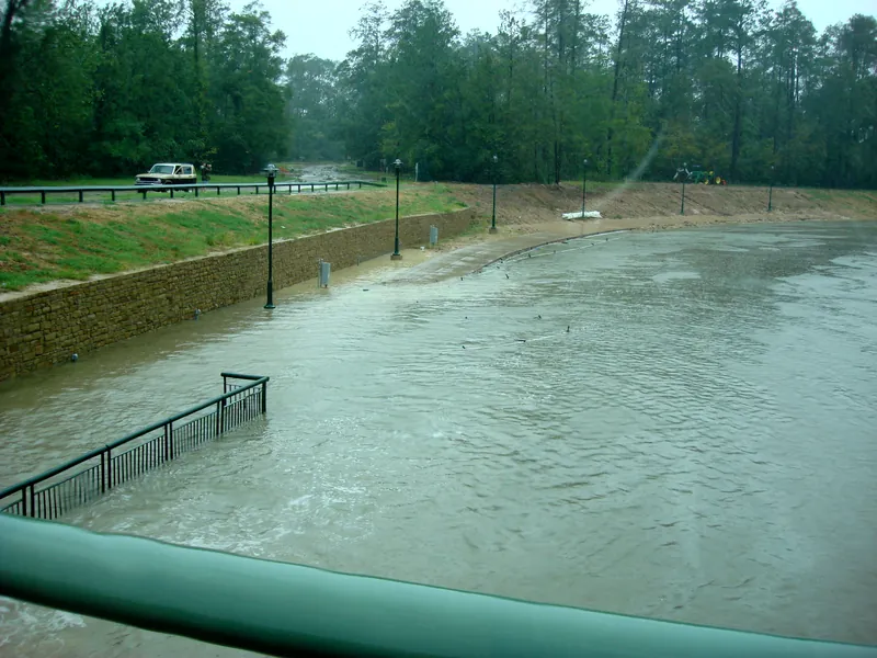 Waterway walkway and railing under muddy floodwater Waterway walkway and railing under muddy floodwater during Hurricane Ike