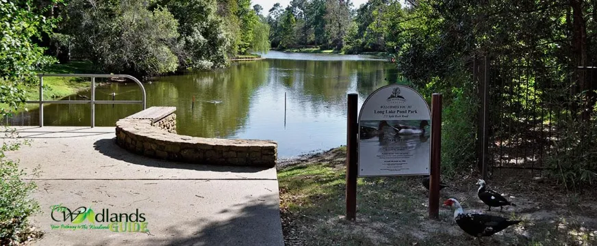 Long Lake Pond Park The Woodlands Panther Creek Village Overlook and park sign on the lake at Long Lake Park, Village of Panther Creek