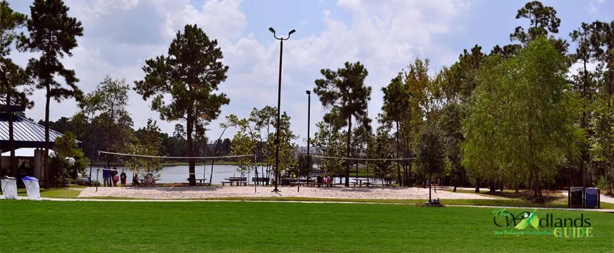 Northshore Volleyball Park The Woodlands Panther Creek Village Lawn and volleyball court beside Lake Woodlands at Northshore Park, Village of Panther Creek
