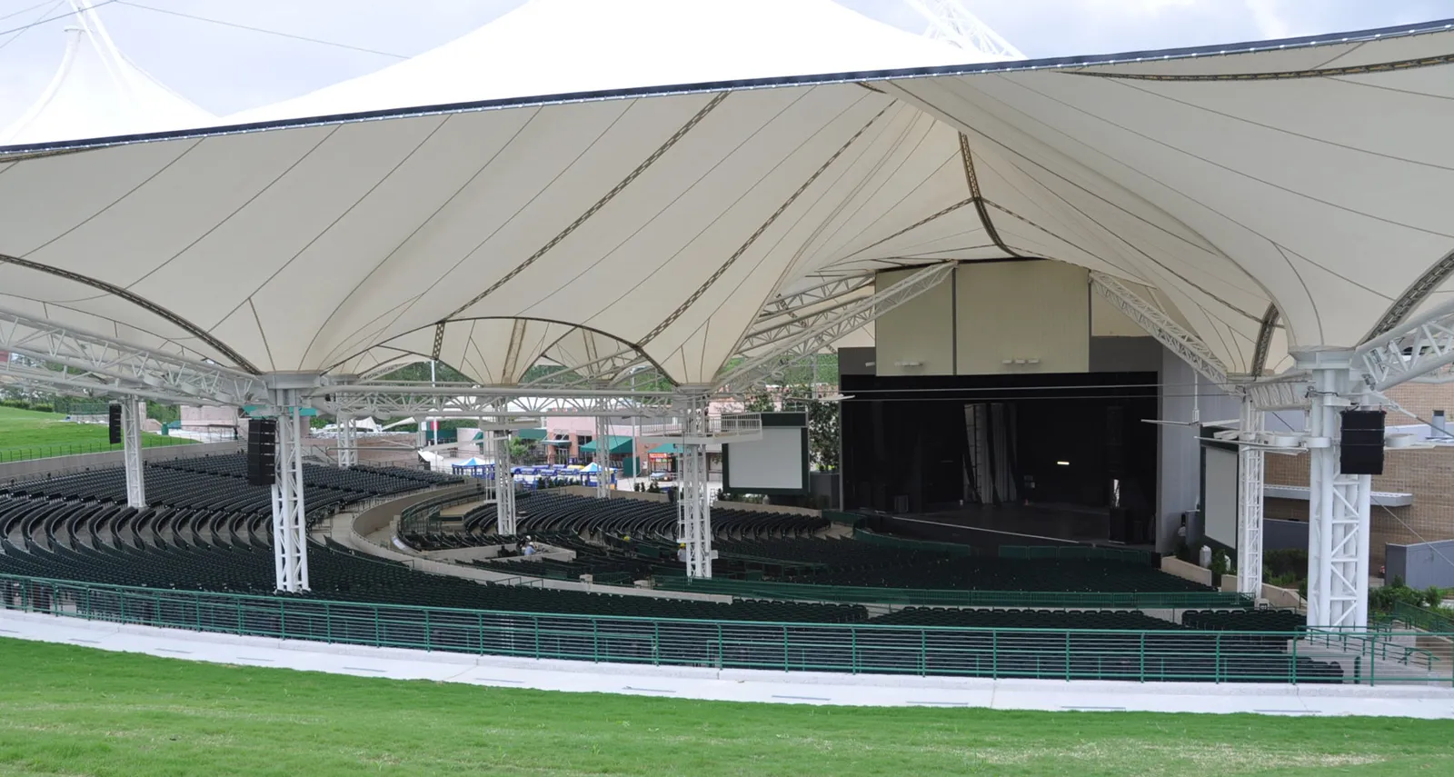 Pavilion reserved seats and tent pillars Reserved seats under the tent at the Cynthia Woods Mitchell Pavilion, with the support pillars and the stage