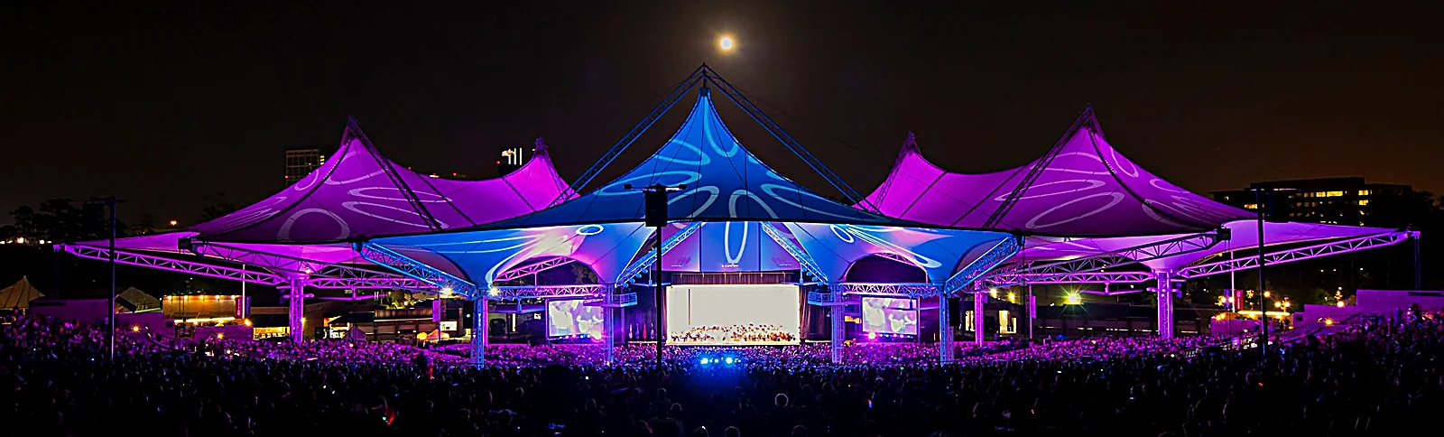 Cynthia Woods Mitchell Pavilion at night The Cynthia Woods Mitchell Pavilion tent lit in blue and purple during a night concert
