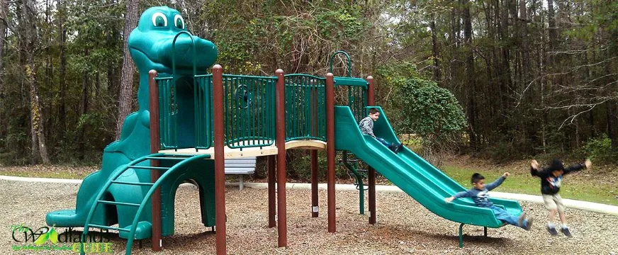 Tallowberry Park The Woodlands Panther Creek Village Green play structure with slides at Tallowberry Park, Village of Panther Creek